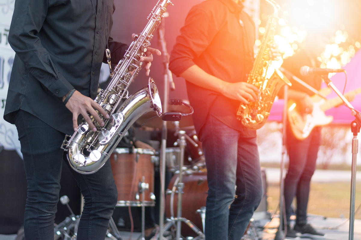 A crowd, cheering on a band.
