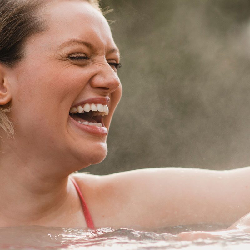 Woman relaxing with friends in hot tub