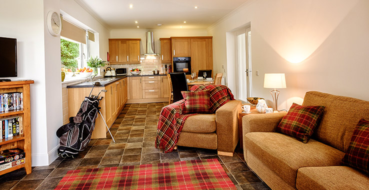 Open plan living area and kitchen in Lodge 6 at Elderburn Luxury Lodges
