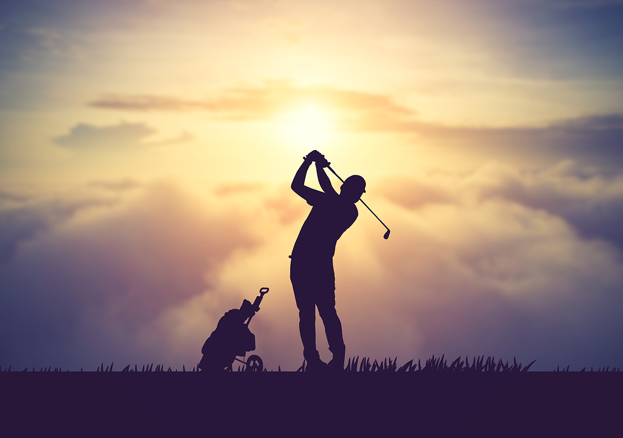 A silhouette of a golfer