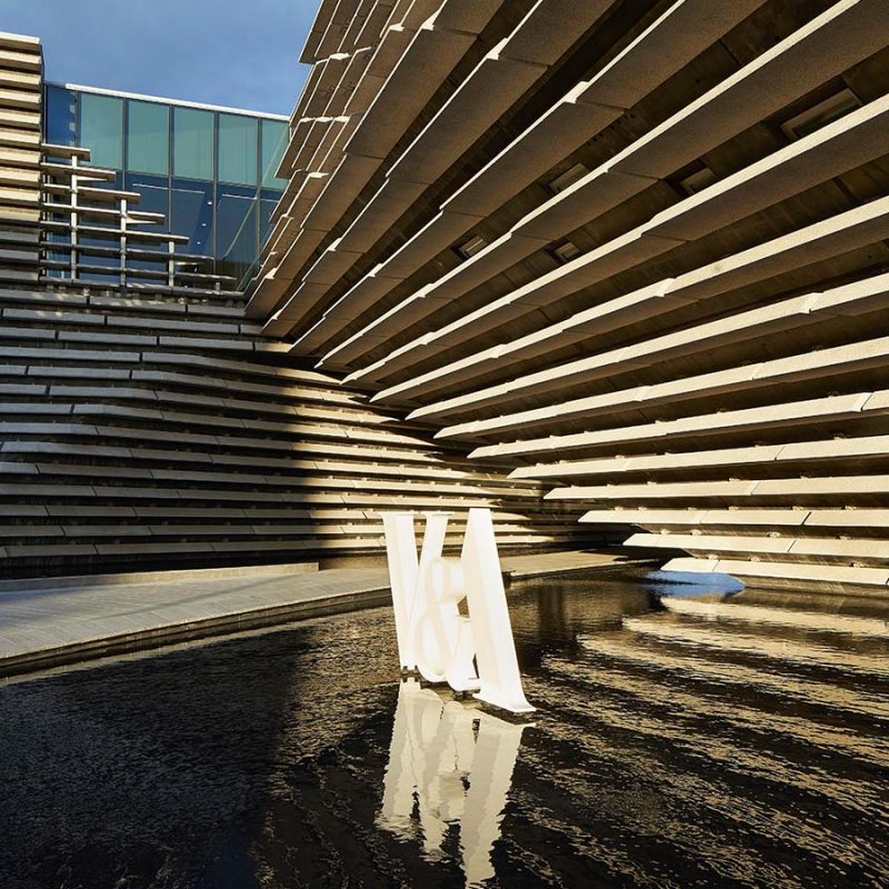 The dramatic exterior of the V&A in Dundee with its signage outside it