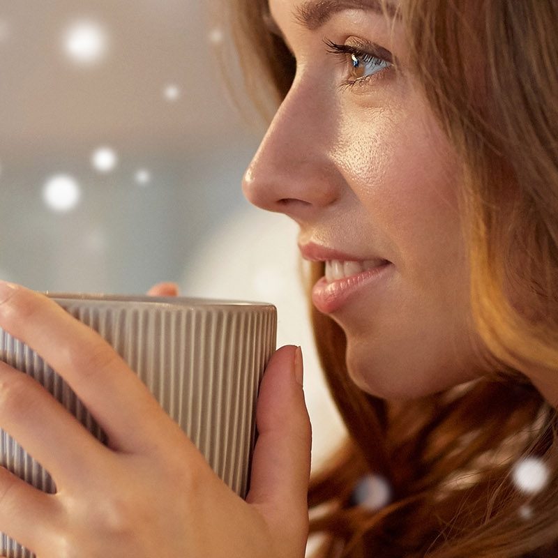 A girl sipping a hot drink