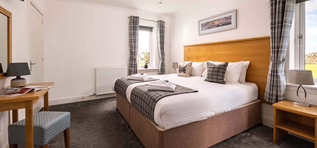 A bright airy bedroom in the accessible Lodge 6 at Elderburn Luxury Lodges