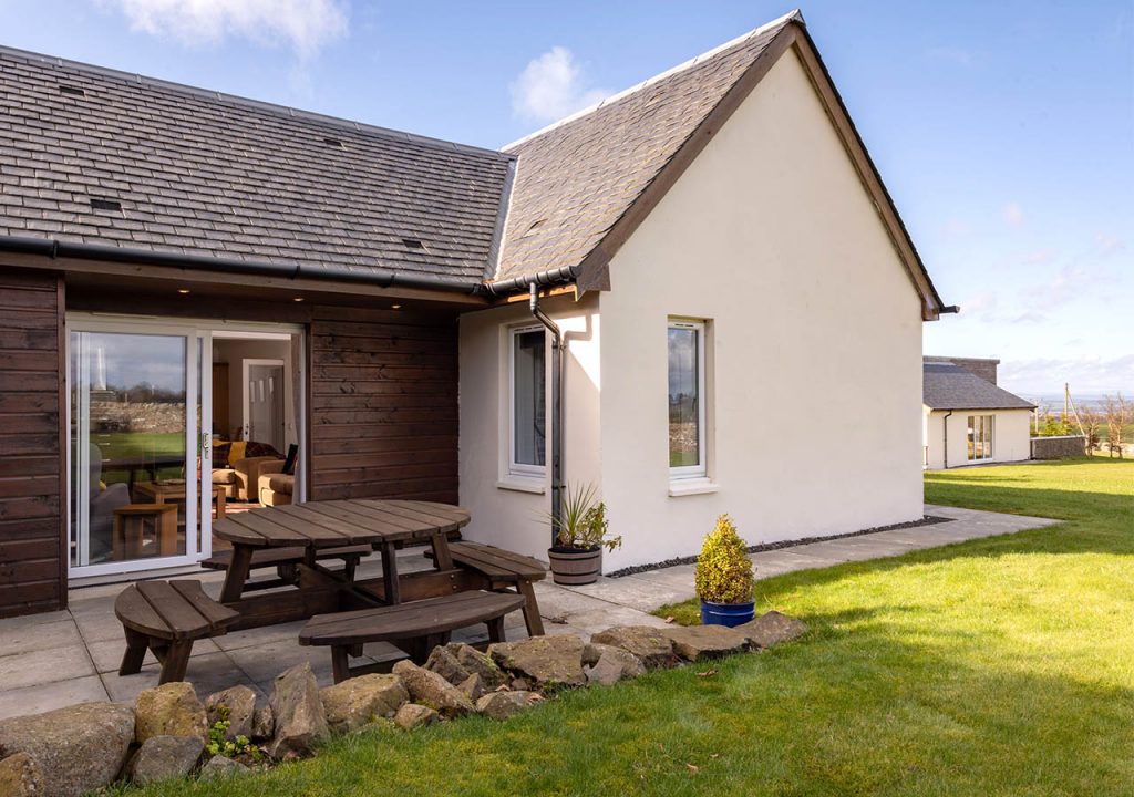 The exterior and patio at the accessible Lodge 6 at Elderburn Luxury Lodges