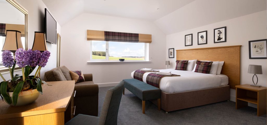 A beautiful double bedroom with stunning views over the countryside at Elderburn Luxury Lodges