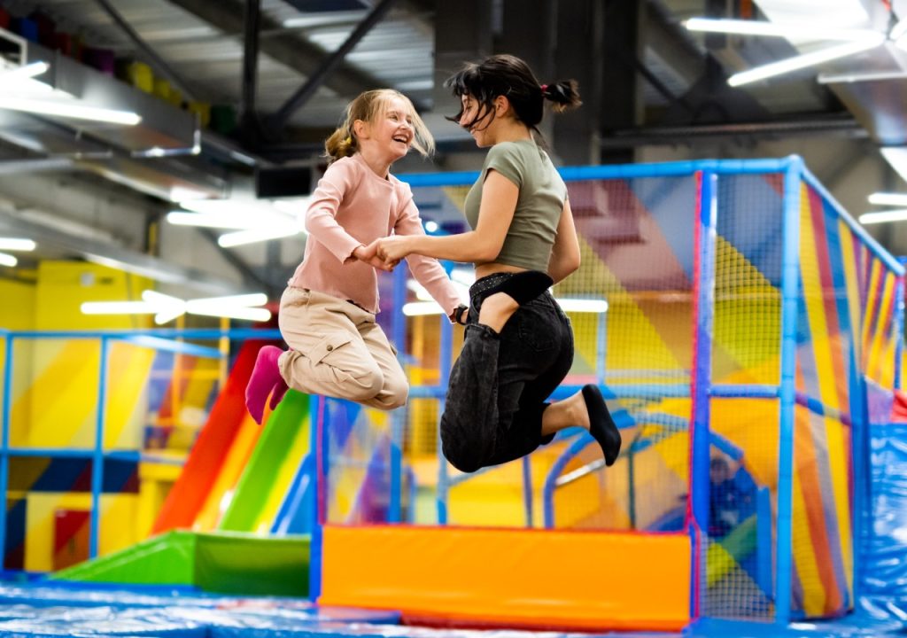 two girls playing on trampoline
