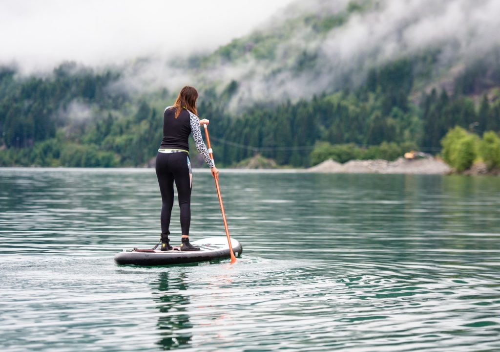 woman paddleboarding on a lake
