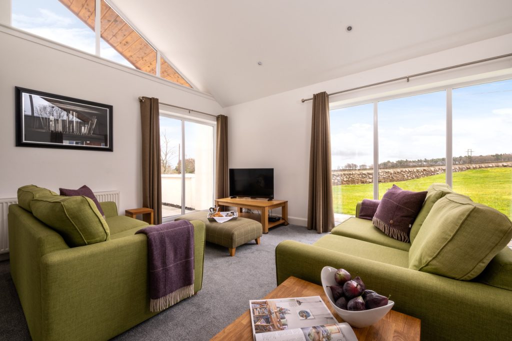 Elderburn lodges cosy living room with a view out to fields