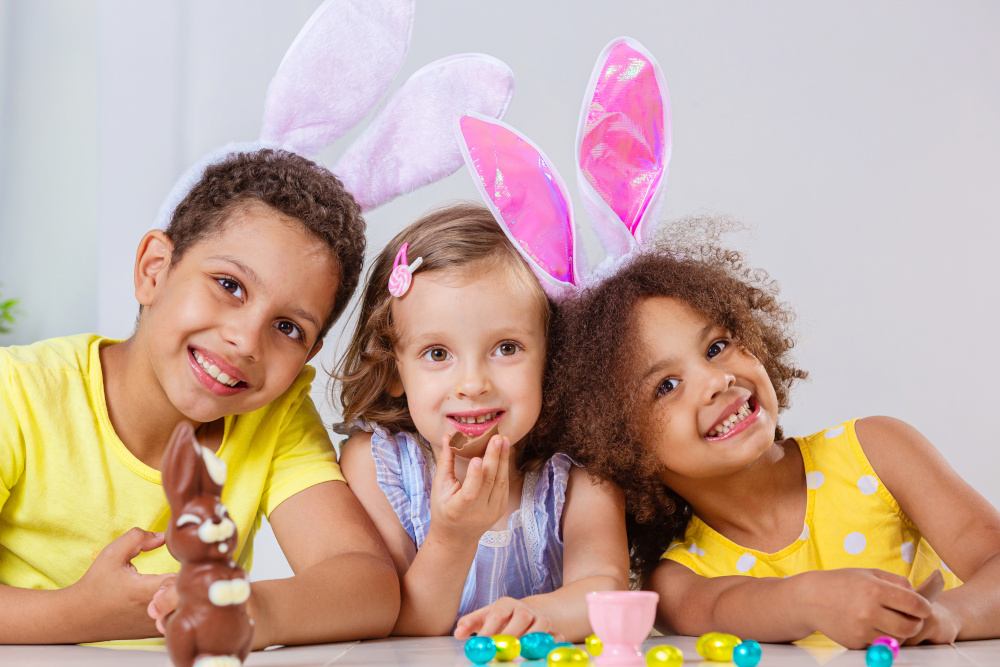 Three children with bunny ears and Easter eggs