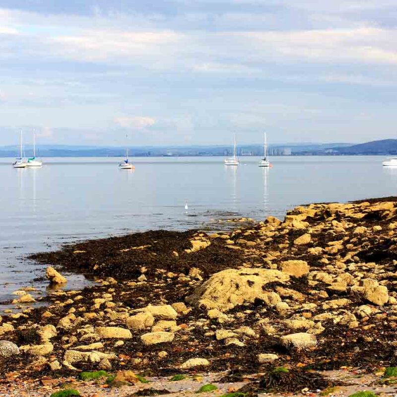 Aberdour Silversands Beach with boats on the water.